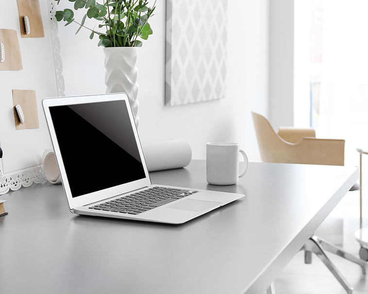 Laptop on a desk for teletherapy in NY